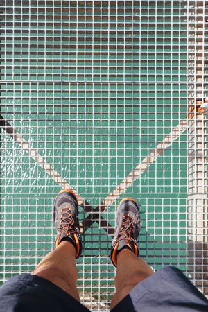 Man legs standing in a bridge