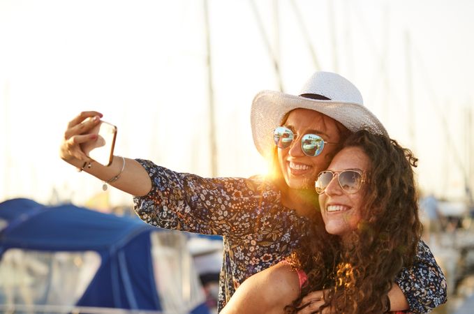 Woman carrying girlfriend on back