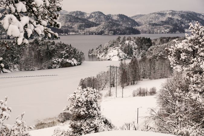 Snowy peaceful mountain valley at shore