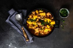 Top view of Georgian meat and vegetable dish Souzi served with herb on counter