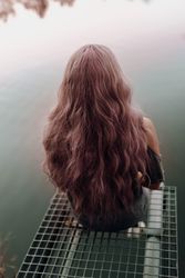 Stylish modern woman sitting on metal pier