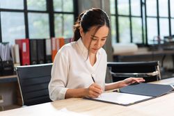 Female reading through report at work