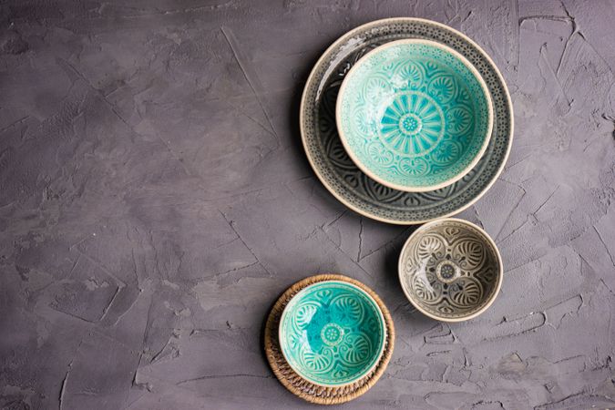 Three plates and bowls on grey background