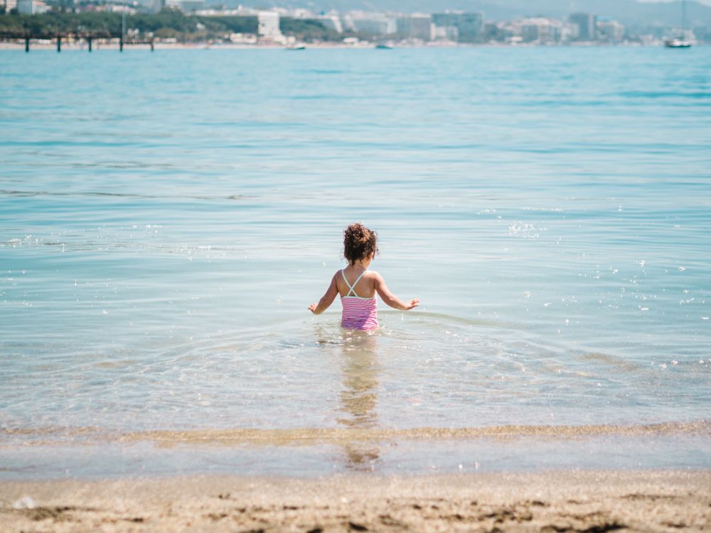 Cheerful girl having fun in warm sea