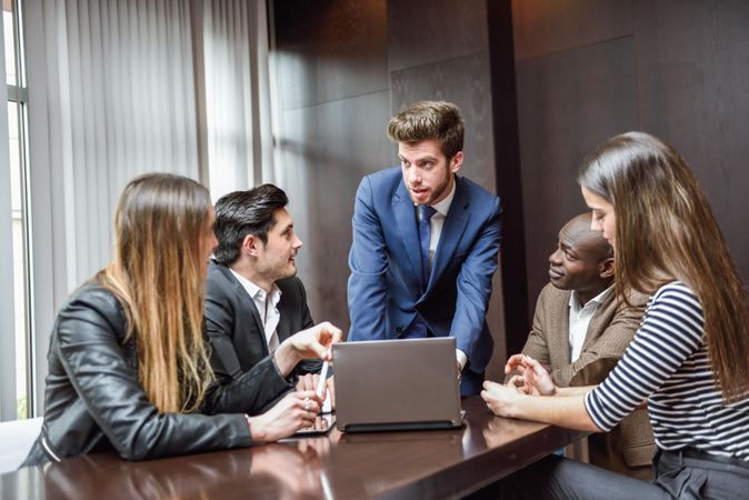 White businessman leading his colleagues in a brain storming meeting at work