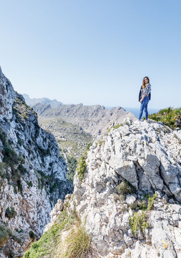 Young woman standing on cliff