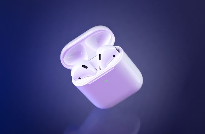 Futuristic wireless earbuds on blue