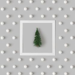 Holiday pattern with tree and snowballs on gray background