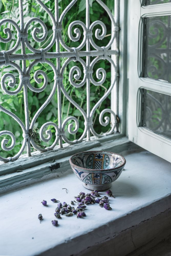 Dried flower buds and bowl near window