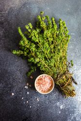 Top view of salt and bunch of fresh herbs