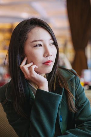 Portrait of young Asian woman looking away