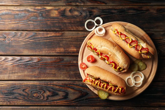Composition with tasty hot dogs on wooden background
