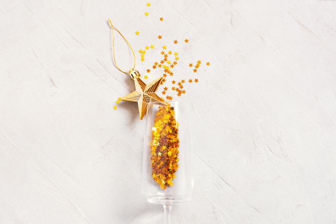Champagne glass with golden star glitter and Christmas decoration