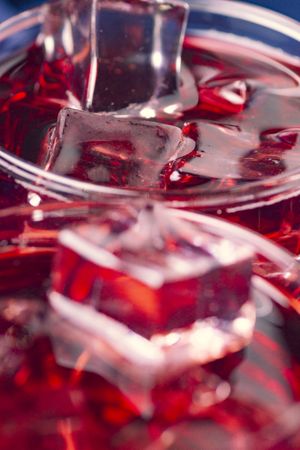 Red beverage near fresh fruits on cloth