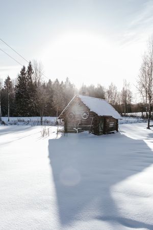 Old house between snow field