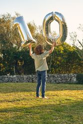 Anonymous boy with number ten made out of balloons