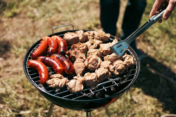 Meat is fried on a campfire, barbecue in nature. Pickled meat is cooked on coals, Grilled BBQ.