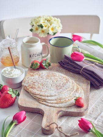Delicious pancakes with berries and chocolate on table