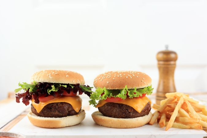 Two Homemade Burger with French Fries on Wooden Table