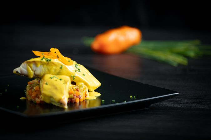 Corvina with yellow pepper sauce in plate