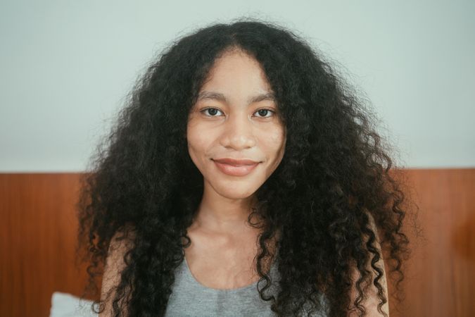 Calm curly hair woman looking at camera