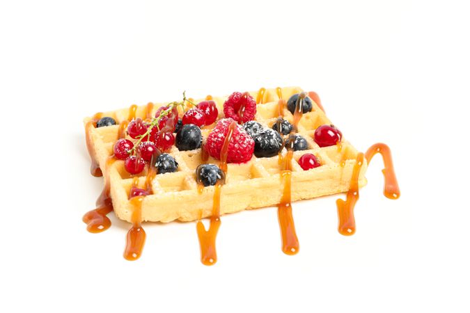 Waffle under caramel topping isolated on blank background