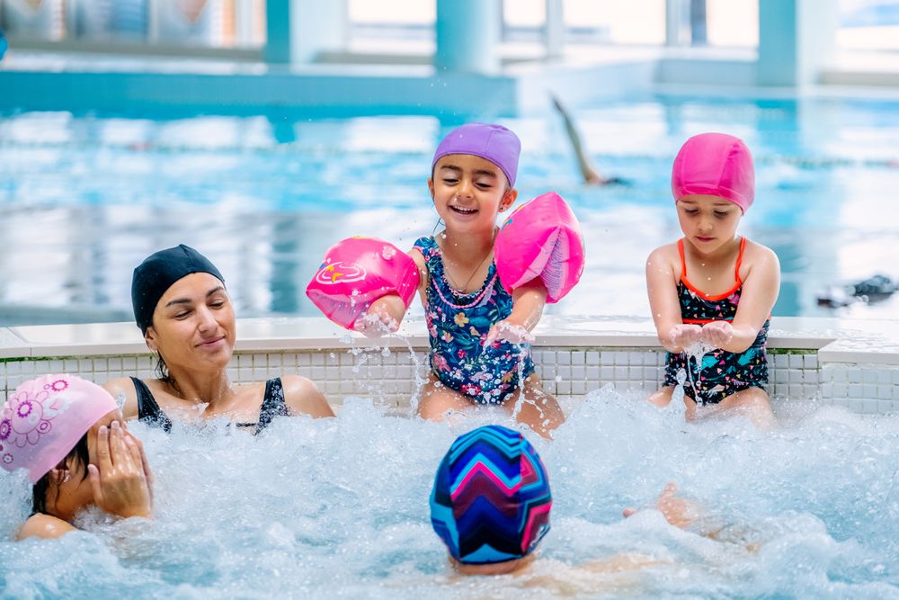 Family relaxing in bubbling pool