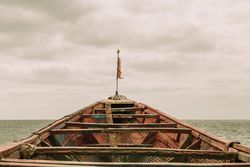 Old boat floating in sea