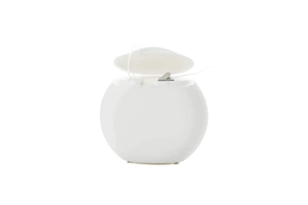 Dental floss plastic case isolated on light background