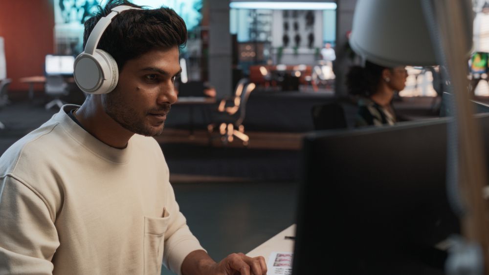Male Indian Game Programmer Coding On Desktop Computer In Game Design Studio Diverse Office.