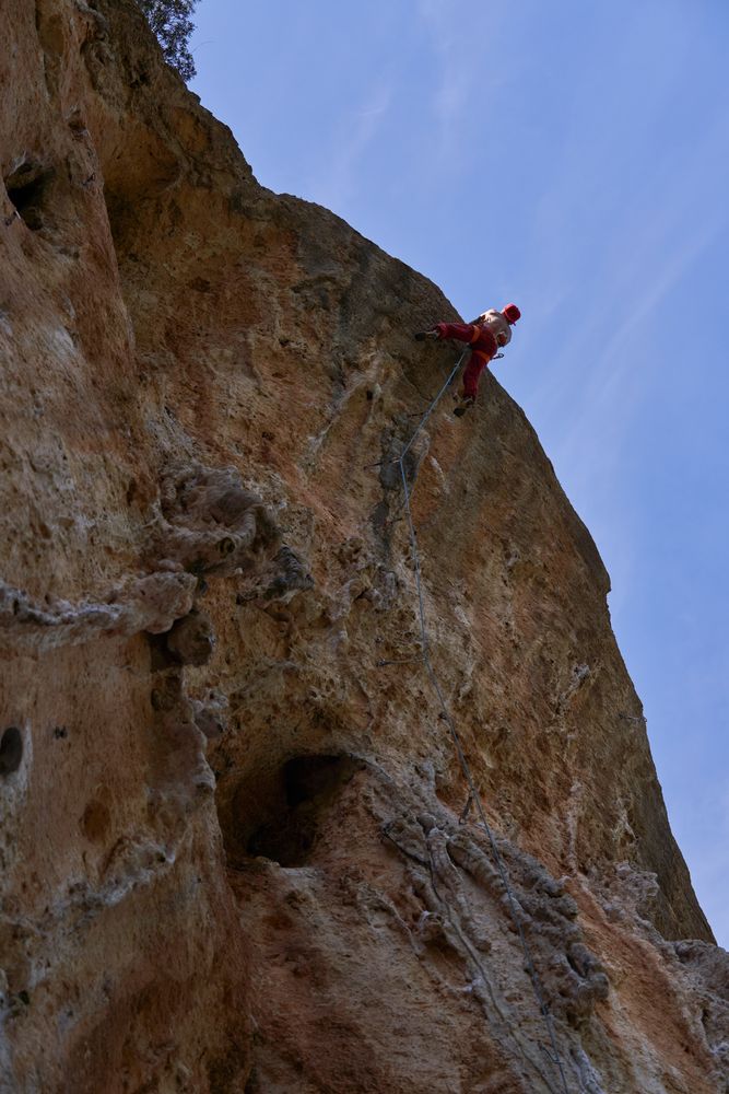 Unrecognizable traveler on top of high cliff