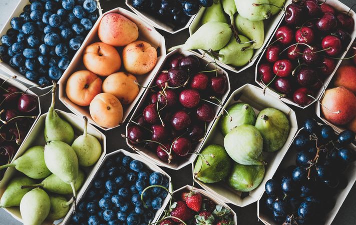 Diagonal rows fresh fruit arranged together in eco-friendly boxed