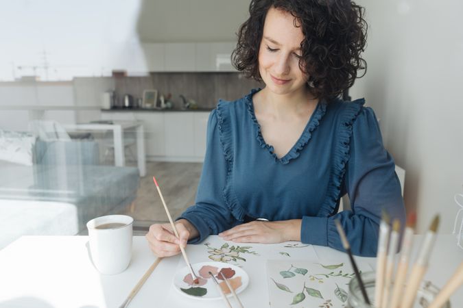 Woman painter working at home