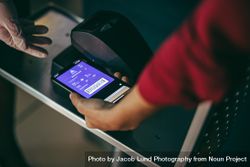 Digital scanning on boarding pass at airport check in counter 42qP75