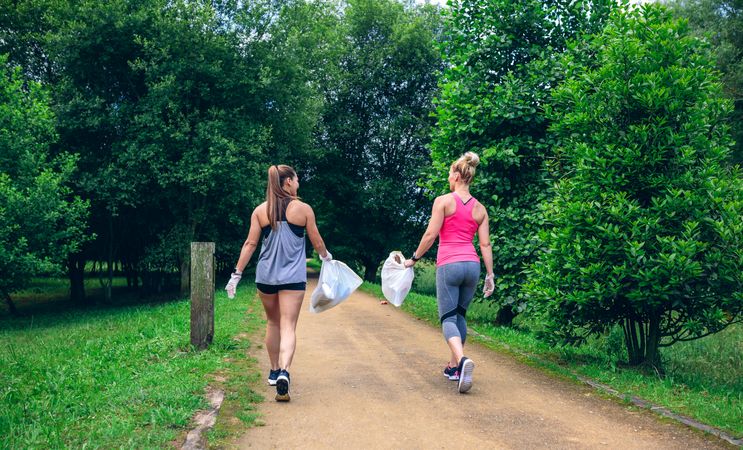 Two women on back doing plogging