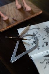Calipers and clay tools laying on anatomy book
