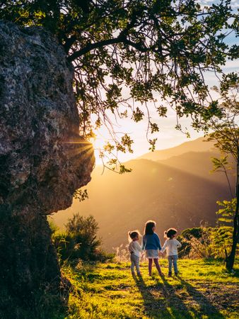 little kids holding hands in nature