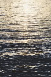 Waves on water surface and sunshine