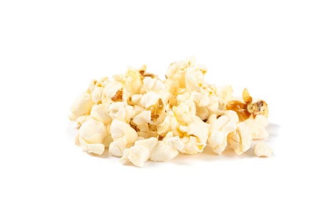 Popcorn pile isolated on blank background, close up