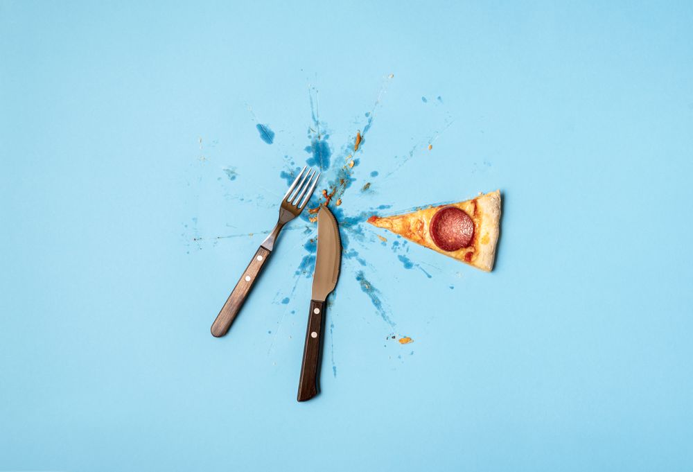Last piece of pizza with utensils