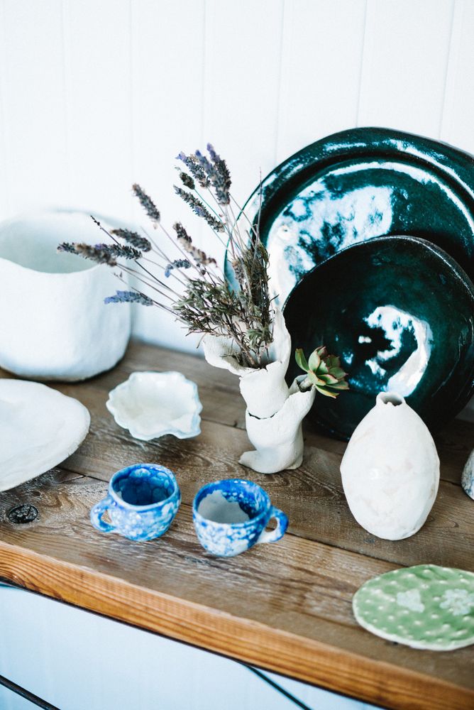 Shelf of ceramic dining ware in artisanal shop