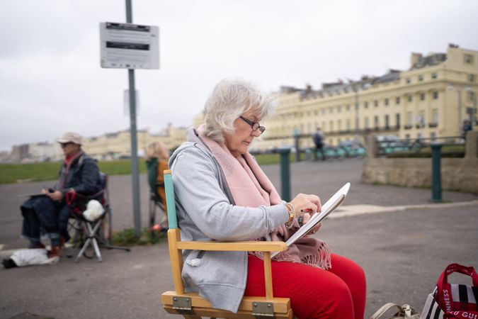 Woman sitting calmly outside drawing