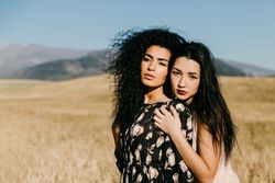 Female friends standing in field