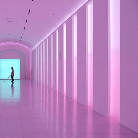 Silhouette of man standing in a pink lit hallway