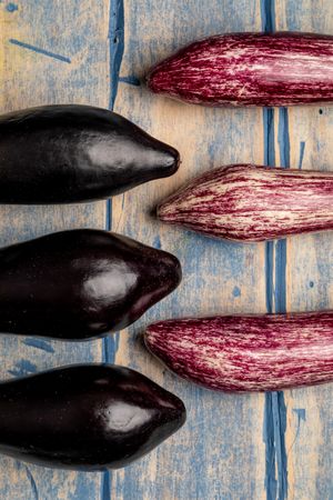 Ripe eggplants on shabby tabletop