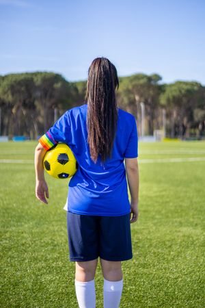 Back of female soccer player with rainbow armband
