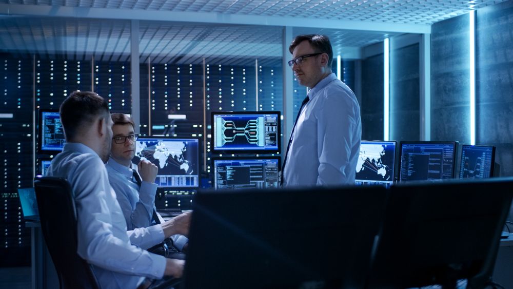 Team of Technical Moderators Have Discussion in Monitoring Room.