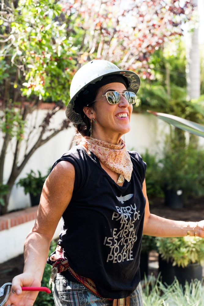 Female contractor working outside wearing sunglasses and hard hat