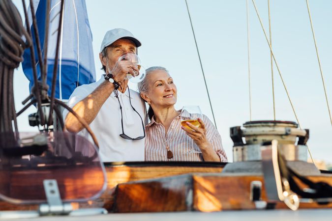 Happy older couple enjoying wine on a boat