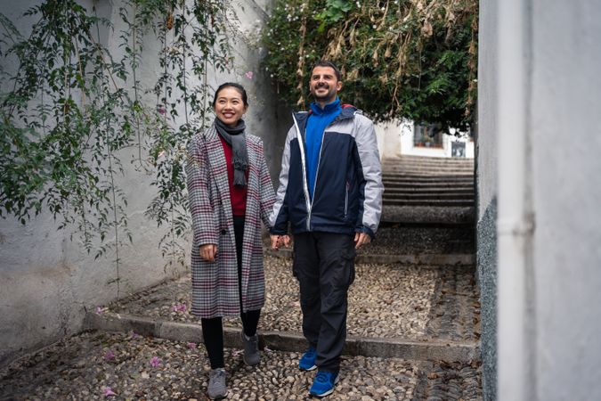 Pleased diverse couple exploring ancient town together